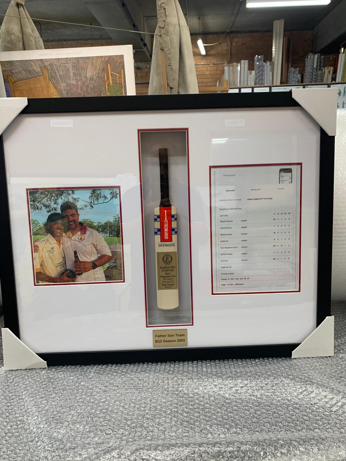 Mini cricket bat framed with a player photo, scorecard and engraved plaque